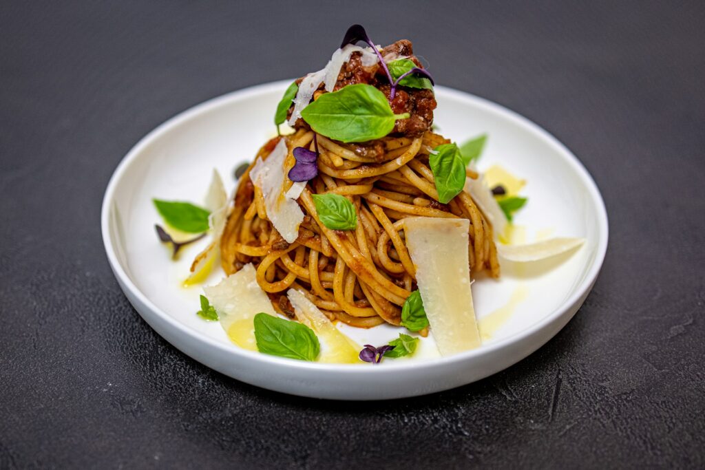 a white plate topped with pasta and vegetables