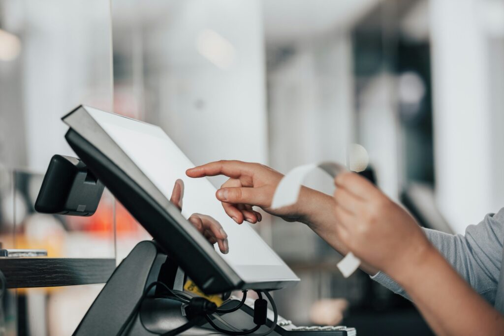 a person using a POS machine in a store